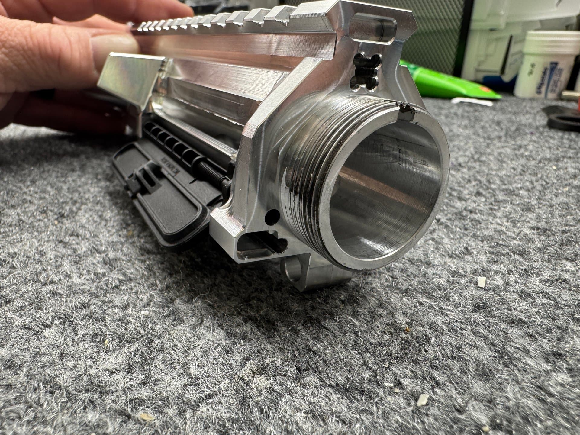 Close-up — machined upper receiver, raw aluminum finish